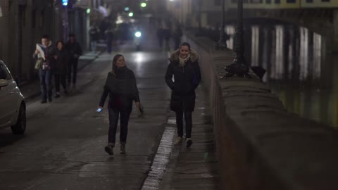 People walking down a busy street at night
