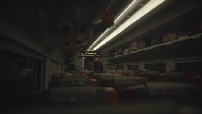 An employee stands in the aisle of a bus