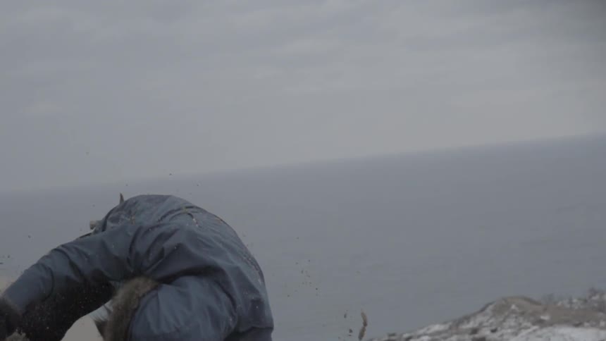 A person rolls down a snowy hill