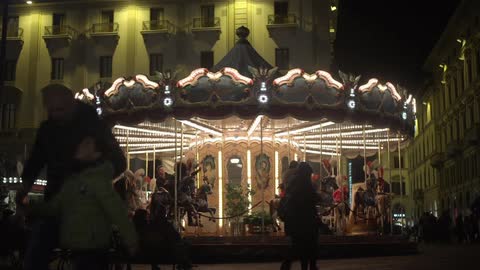 A carousel in a city at night