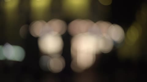 Lights circle, while people walk past