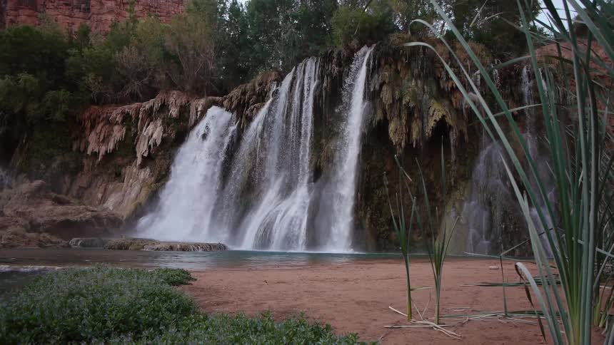 A waterfall with birds flying by