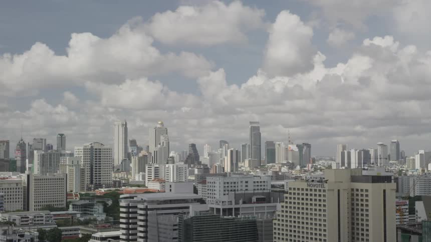 Timelapse of a city with clouds moving on a partly-cloudy day