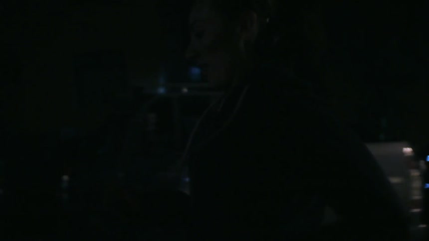 Woman running down a street at night