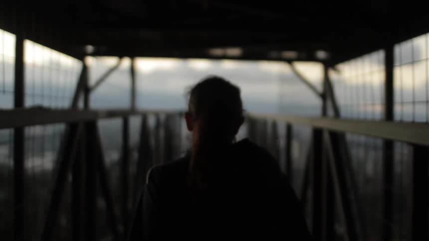 Woman walking on a platform on a cloudy day