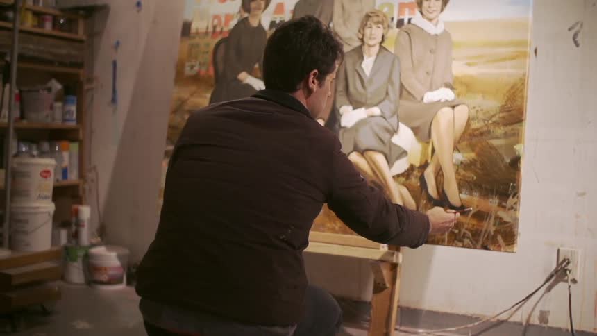 Man putting finishing touches on a painting