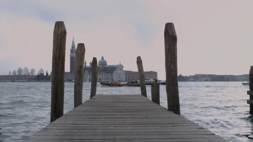 Boats travel across the sea with the skyline in the background
