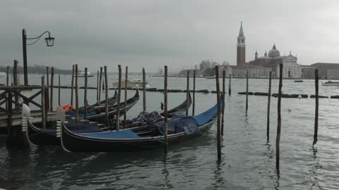 Small boats docked on a cloudy day