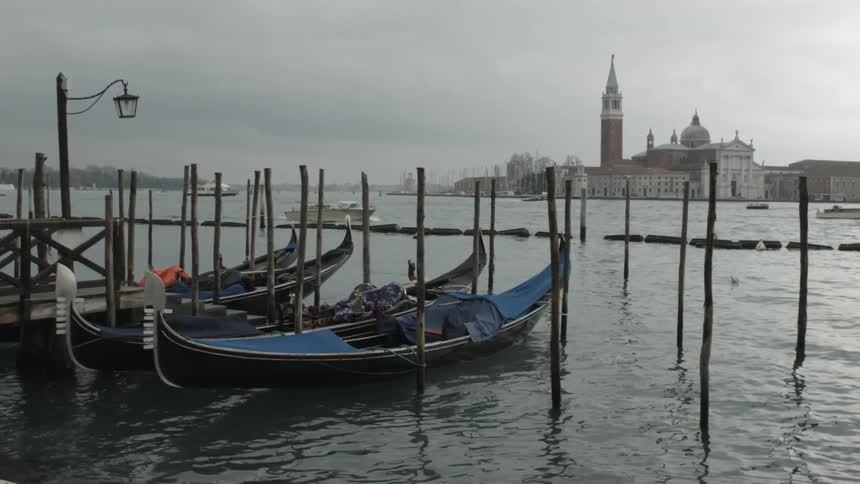 Small boats docked on a cloudy day