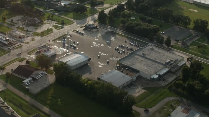 View of a parking lot and road with cars on a sunny day