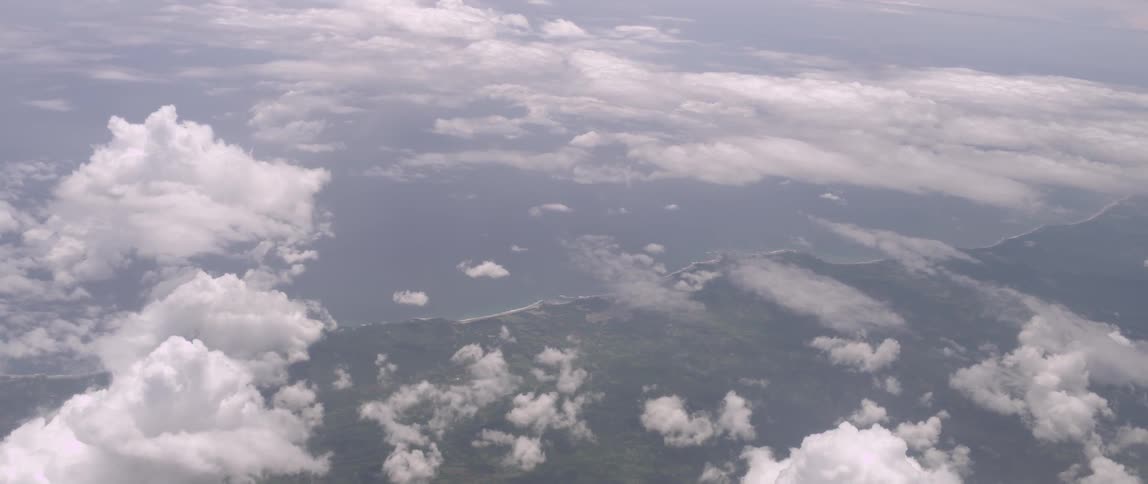 View above the clouds with a coast underneath