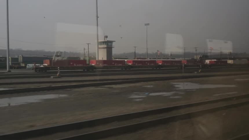 View of train tracks from a moving train