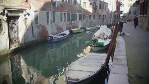 Man working in small boat on a canal