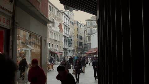 Crowds of people walking in a town square