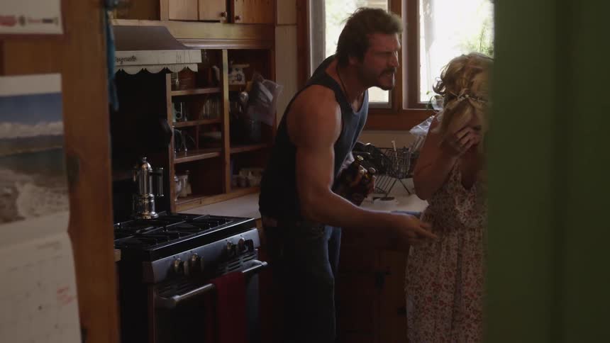 A man and woman argue in the kitchen