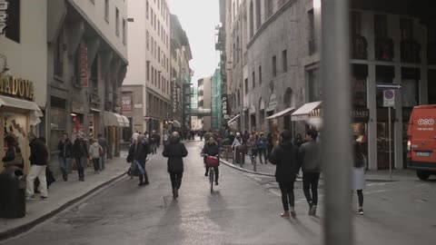 Pedestrians walk down a city street