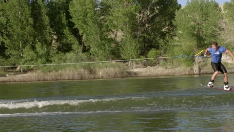 A young man is wakeboarding