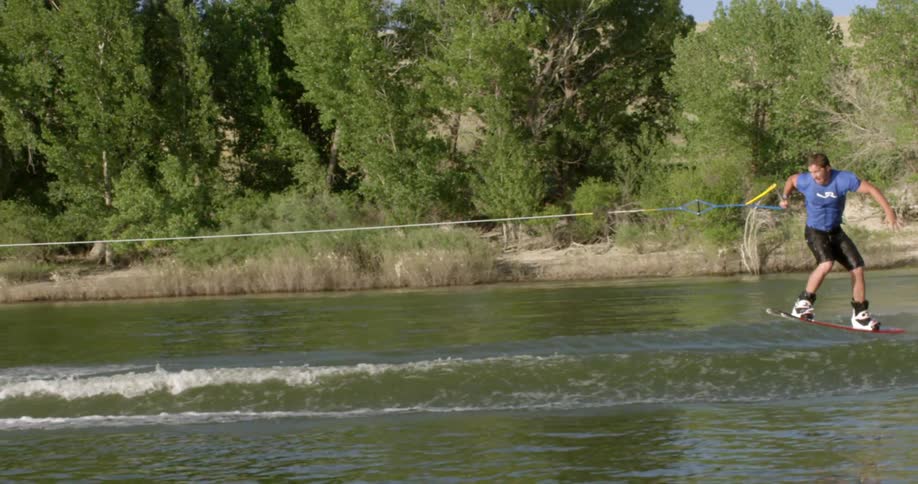 A young man is wakeboarding