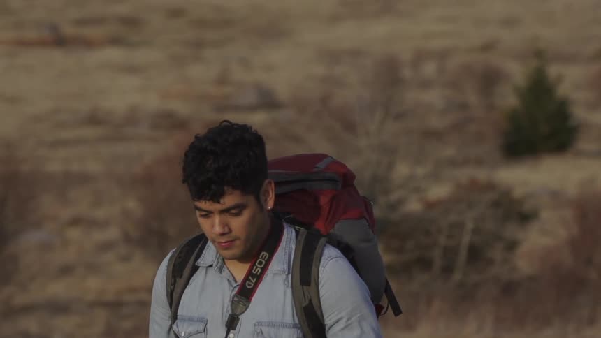 Man hiking as he looks down on the ground
