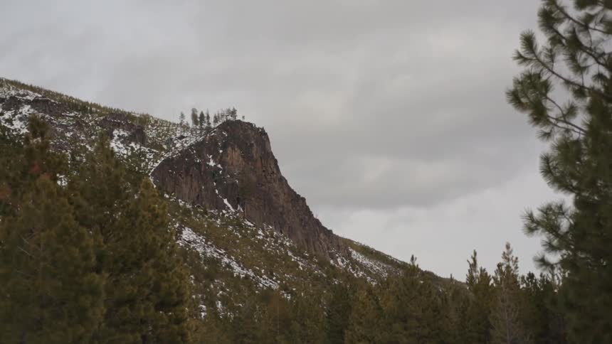 Snow covered mountain in the distance on a cloudy day