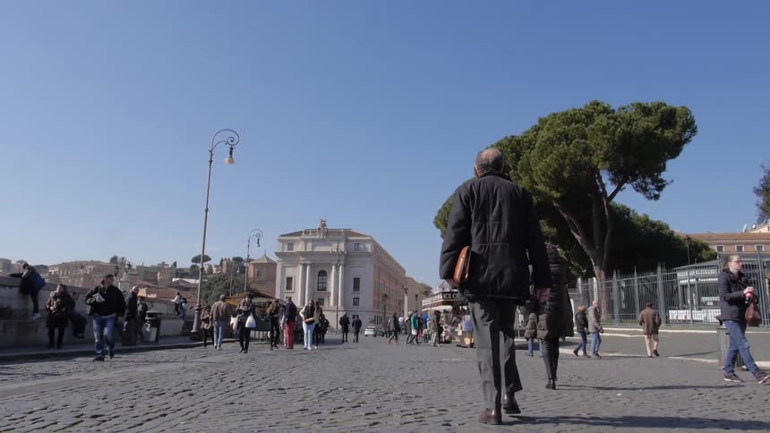 Busy street with many people walking on a sunny day