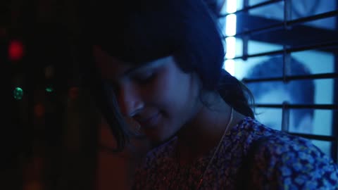Woman smiling in a dark room