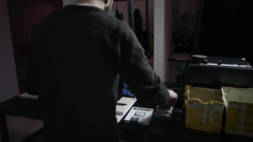 A man adjusts the dials on a piece of machinery