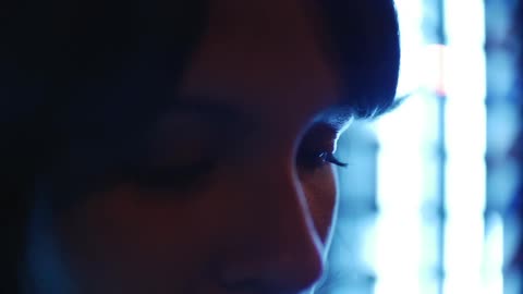 Woman examining something before looking up
