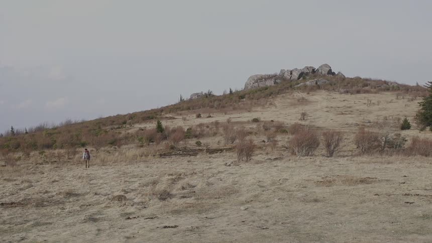 Person traveling down a hill on a cloudy day