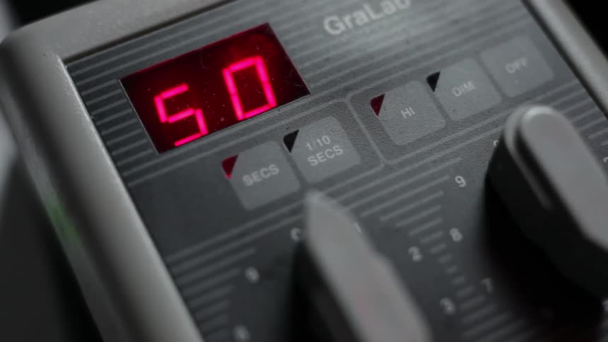 Someone adjusts a dial on a machine