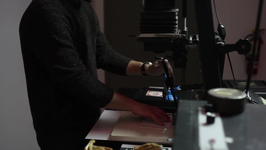 Man cutting paper with a machine