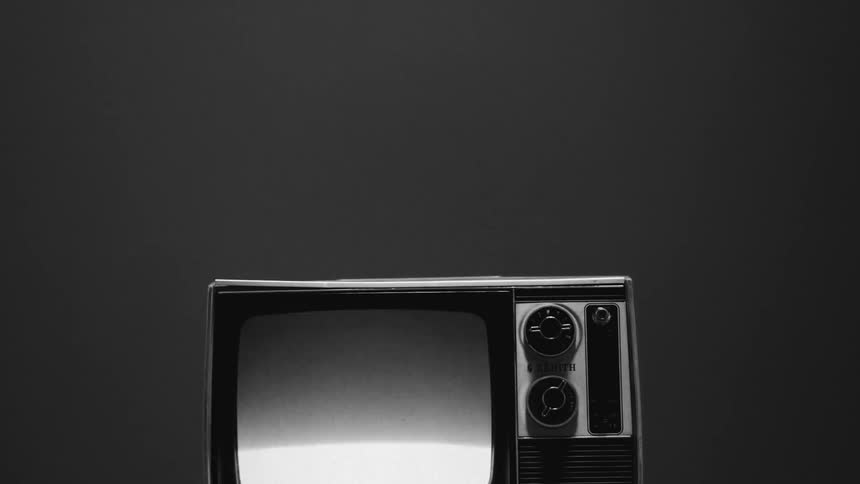 An old tv with the screen flashing because it is not receiving a picture