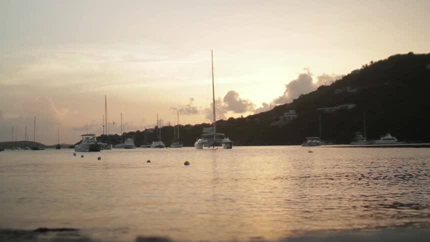 View of boats docked on the water at sunset