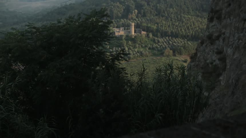 View of a building set in a forest on a cloudy day