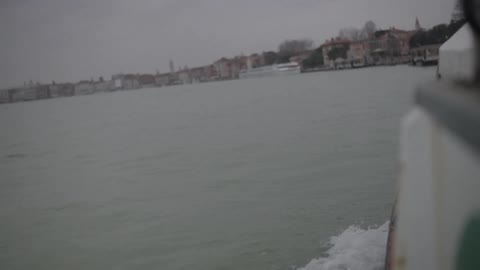 Boat traveling on water on a cloudy day