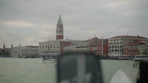 View from the water of some buildings on a cloudy day