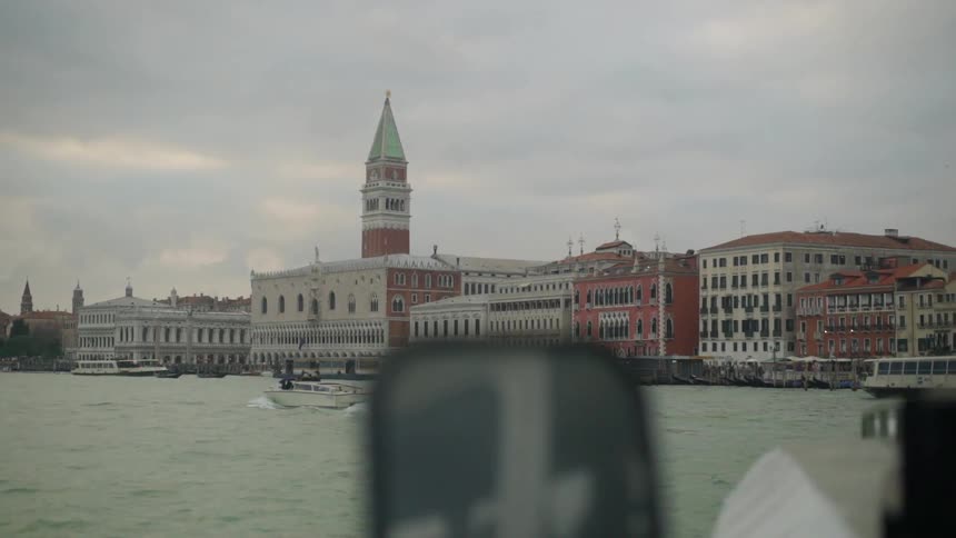 View from the water of some buildings on a cloudy day