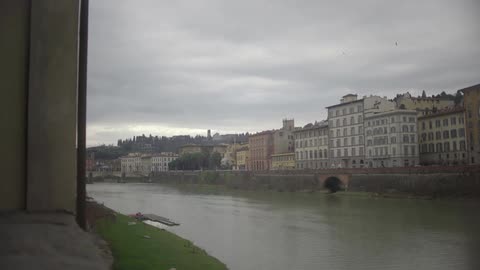 A canal with heavy clouds over buildings