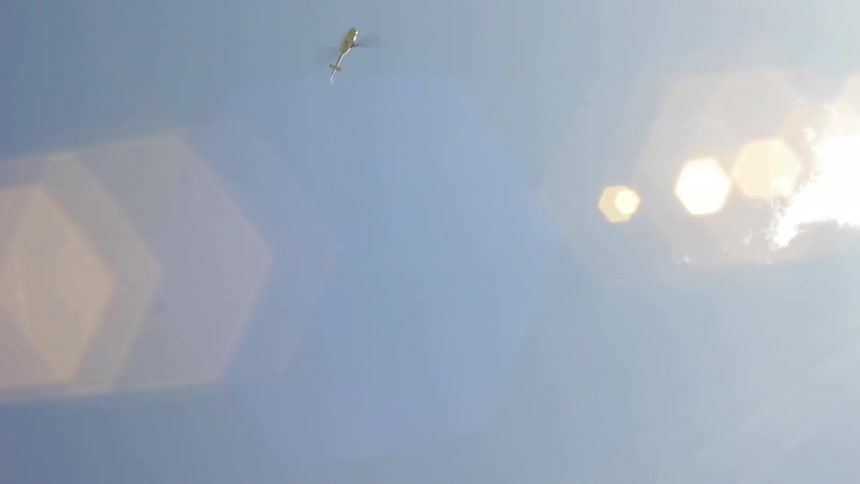 Helicopter flies in the air on a sunny day