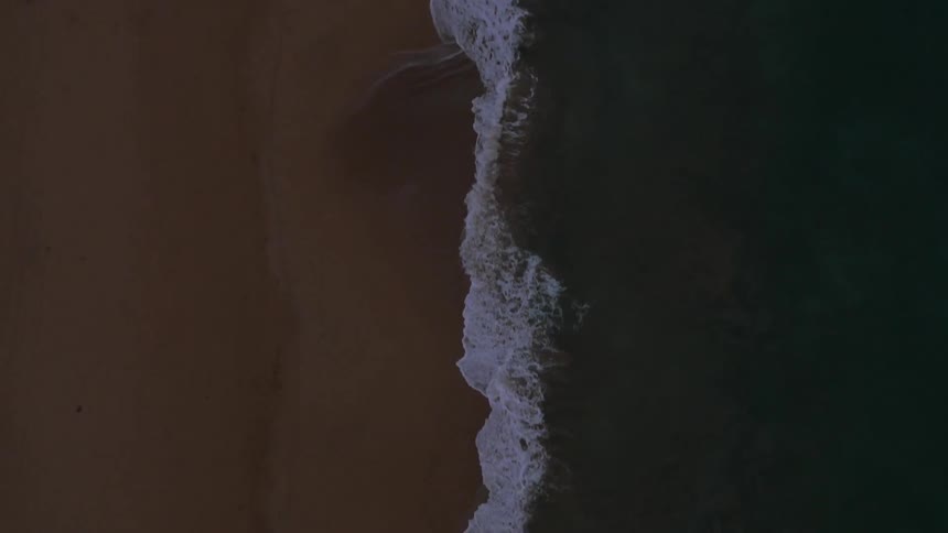 Waves hitting the shore of a beach