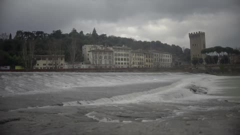 Water pouring over a rocky shore on a cloudy day