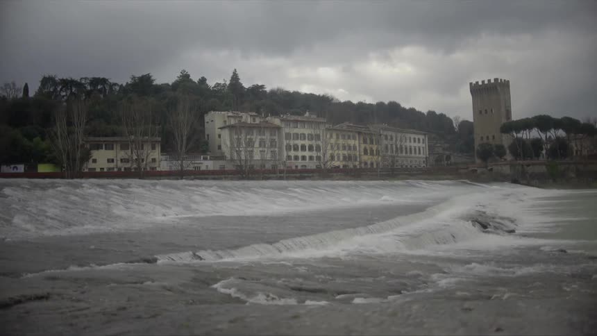 Water pouring over a rocky shore on a cloudy day
