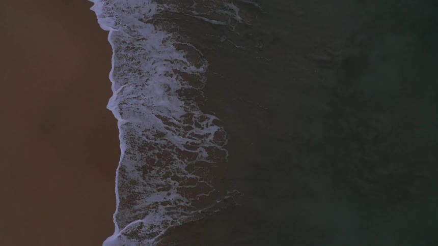 Waves crashing on to, and receding, from shore