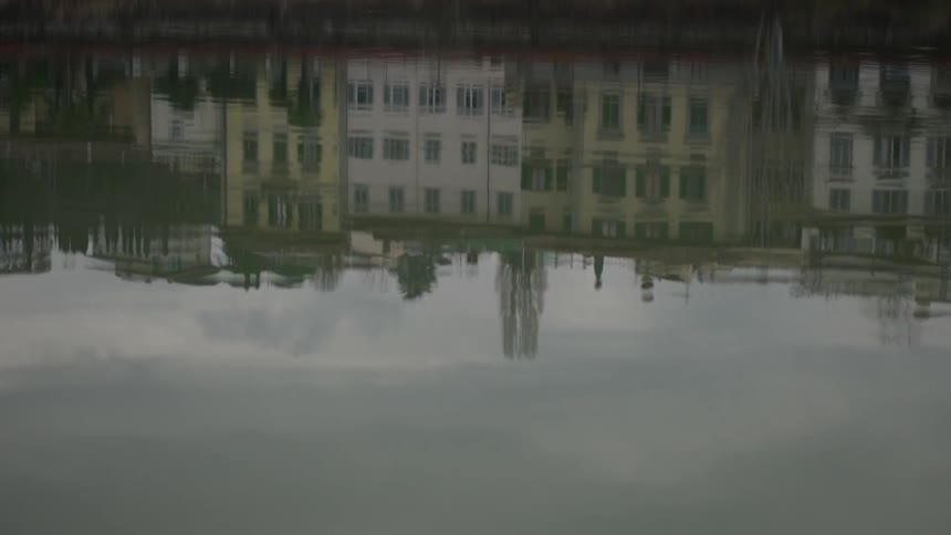 Reflection of buildings from water on a cloudy day