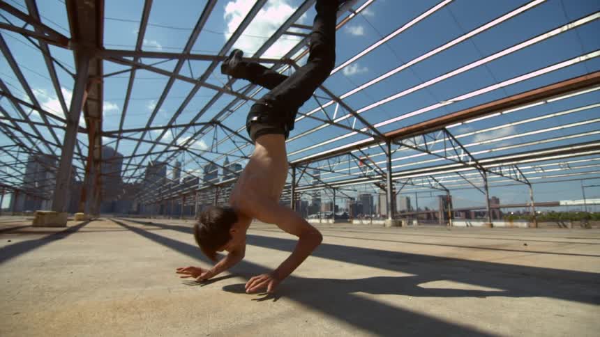 Man break dancing on a sunny day