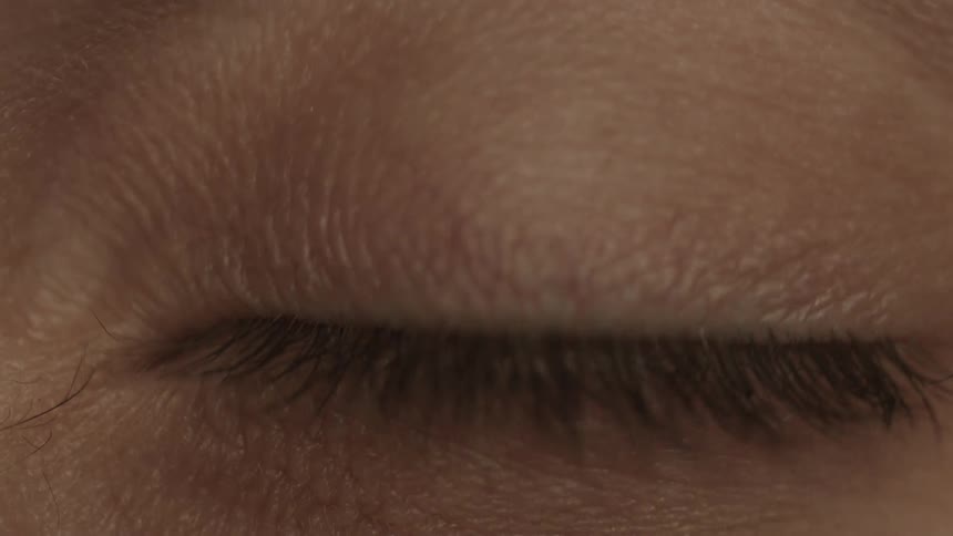 Woman opens and closes her eye