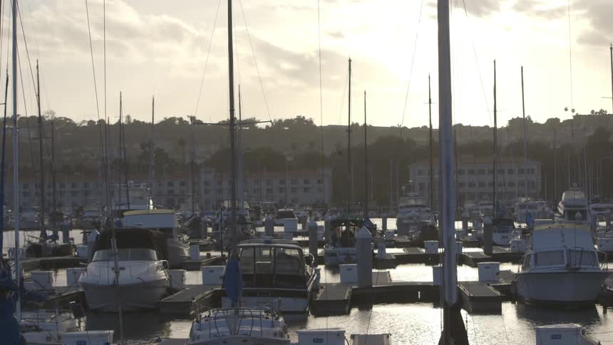 Boats sitting at the dock at sunset