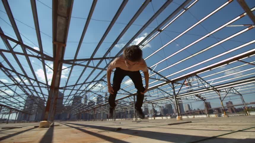 Man doing a flip on a sunny day