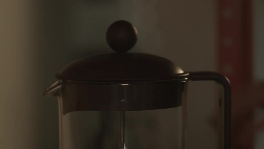 Someone picks up a pitcher in a dark room
