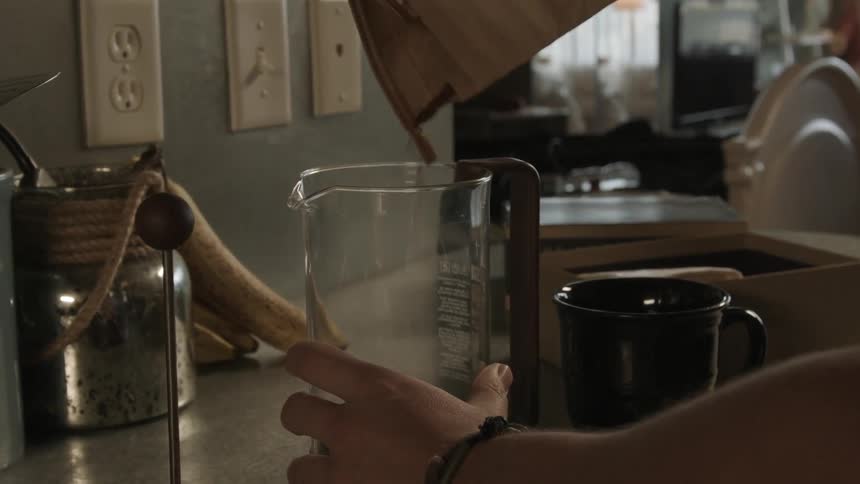 Person filling a pitcher from a bag